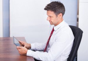 Businessman Looking At Digital Tablet